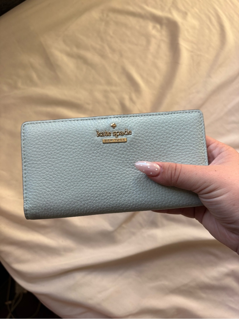 kate spade pebble leather continental wallet in pale blue with gold logo